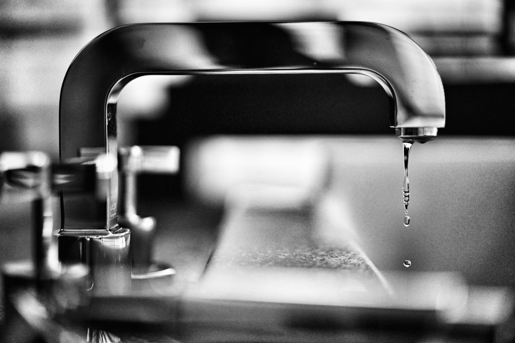 commercial plumber Sunshine Coast- black and white image of faucet